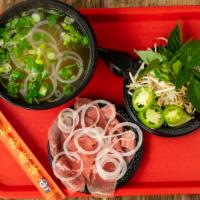 Rare Eye Round Steak Pho (Phở Tái) · Traditional Vietnamese soup made with a rich beef broth, tender rice noodles, and choice of ...
