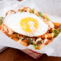 Kimchi Fries · Seasoned fries with homemade kimchi, drizzled with our house sauce!
