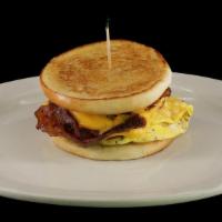 Bw Deluxe Sandwich · Grilled bun loaded with eggs, bacon, sausage, ham and smothered with swiss and american cheese