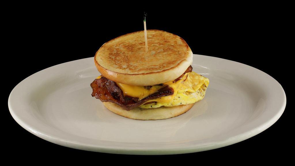 Bw Deluxe Sandwich · Grilled bun loaded with eggs, bacon, sausage, ham and smothered with swiss and american cheese
