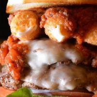 Mozzy Burger · Topped with Provolone cheese, mozzarella sticks, marinara sauce, mixed greens, tomato and on...