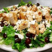 Nutty Chicken Salad · Grilled Chicken, feta cheese, almonds, grapes, raisins and dried cranberries on a bed of mix...