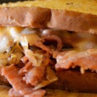 Reuben · Grilled corn beef, topped with sauerkraut, swiss cheese, and thousand island sauce.
