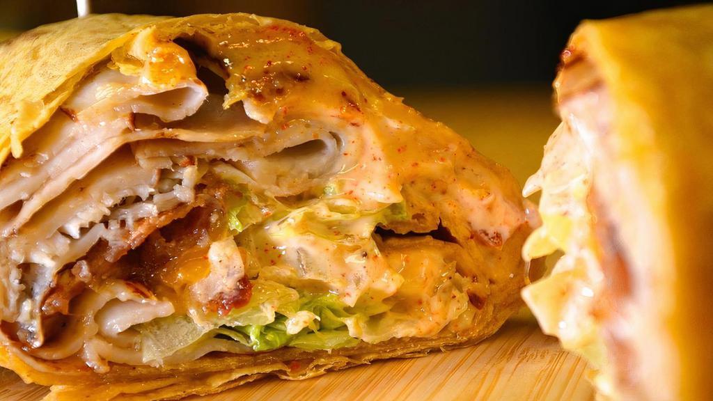 Chicken Ranch Wrap · Grilled chicken, cheddar cheese, mixed greens, tomato, onion, and ranch dressing