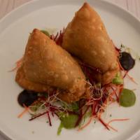 Samosa · Delicately seasoned potato and petite pea turnovers served with tamarind and mint chutney.