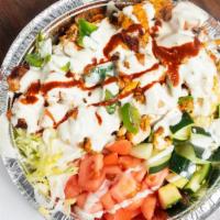 Chicken Over Rice · With rice and salad white sauce and hot.