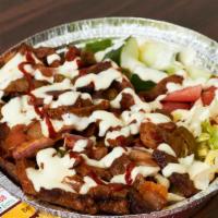 Lamb Over Rice · Lamb with rice and salad, white sauce and hot sauce.