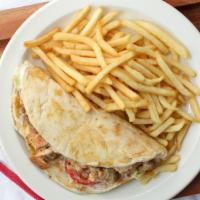 Halal Chicken Gyro · With French fries and can of soda.