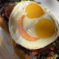 Huevos Rancheros · Two crisp corn tortillas topped with refried beans, grilled steak, fried eggs, salsa de toma...
