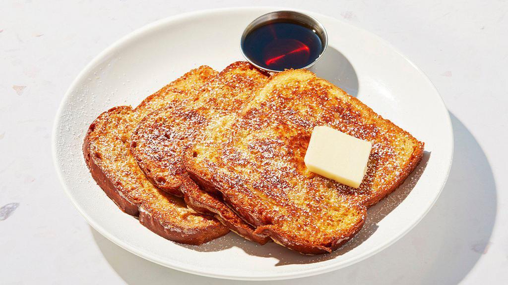 French Toast · Four slices of thick, egg-washed cinnamon bread served with maple syrup and powdered sugar.
