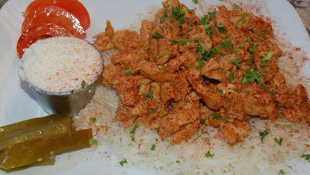 Chicken Shawarma · A healthy portion of our famous chicken shawarma served with garlic paste, rice and one side of your choice.