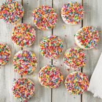 Sprinkled Dozen · One dozen 3-inch sugar cookies frosted white with sprinkles. (Sprinkle colors vary with seas...