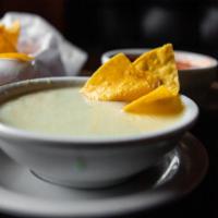 Queso Blanco · Our famous creamy melted cheese dip.