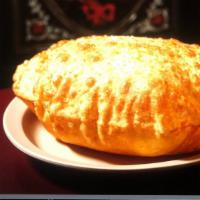 Batura · Deep-fried large puffy bread.