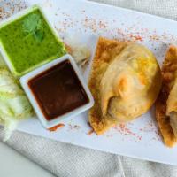 Samosa · Crispy cone pouches stuffed with potatoes, green peas and spices.