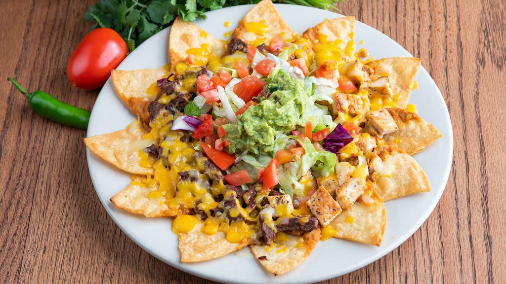Nachos · Twelve large corn tortilla chips topped with beef or chicken
fajita, beans, cheese, guacamole, jalapeños, lettuce and
tomatoes.