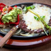 Carne Asada · A 10oz. Choice skirt steak topped with Monterey cheese.
Served with guacamole, pico de gallo...