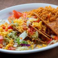 Crispy Tacos · 3 ground beef crispy tacos, topped with lettuce, tomatoes and cheese. Served with rice and r...