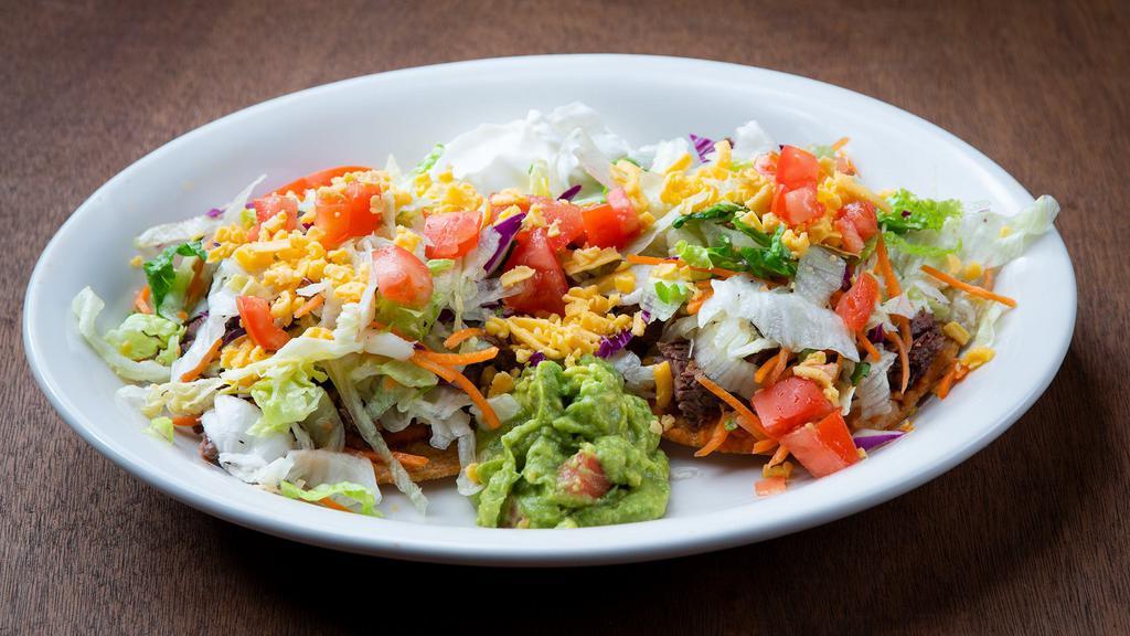 Tostadas · 2 ground beef or chicken tostadas. Served with lettuce, tomatoes, beans, cheese, sour cream and guacamole.