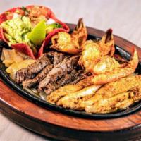 Cazador Mix · A tantalizing mix of beef, chicken, and shrimp fajitas. Served with charro beans, rice, guac...