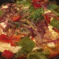 Baked Greek Feta · Roasted feta cheese with green peppers, onions, tomatoes and EVOO.