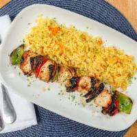 Chicken Kabob · Tender chunks of marinated chicken flame grilled served with rice and side Greek salad.