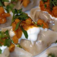 Mantoo · Steamed dumplings, stuffed with ground beef, onion, and seasoning, topped with yogurt, and m...