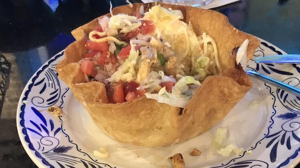 Taco Salad · Crispy flour tortilla shell filled with beef or chicken, beans, lettuce, pico de gallo, cheese dip, sour cream, and guacamole.