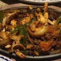 Fajitas Marinas · Grilled shrimp, scallops, and fish cooked with vegetables. Served with beans, guacamole sala...