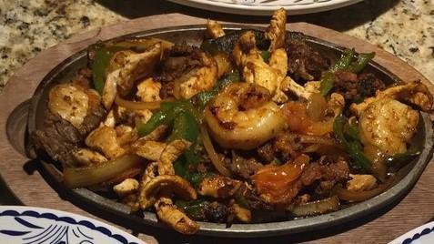 Fajitas Marinas · Grilled shrimp, scallops, and fish cooked with vegetables. Served with beans, guacamole salad, and tortillas.