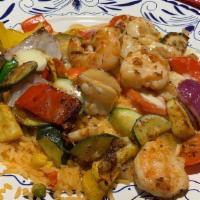 Camarones Locos · Favorite. Grilled shrimp, scallops, bell peppers, onions and zucchini served over rice and o...