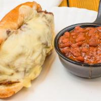 Brisket Cheesesteak · Chopped beef brisket, grilled onions, American cheese, chipotle BBQ sauce on a sub roll.