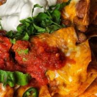 Basic Nacho'S · Tortilla chips layered in beans, cheese & jalapenos, w/ salsa & sour cream