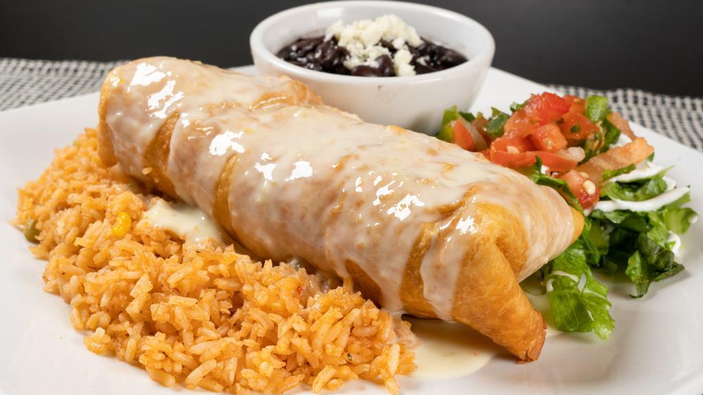 Chimichangas · A crispy flour tortilla stuffed with your favorite filling, then topped with queso. Garnished with lettuce, sour cream and pico de gallo. Served with rice and your choice of black or refried beans.