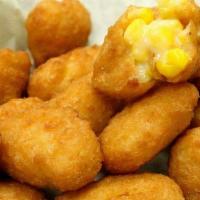 Corn Fritters · Lightly battered sweet corn nuggets with local maple syrup to dip.