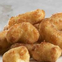 Cheese Curds · Made with fresh natural white cheddar cheese curds, lightly battered fried & served with ran...