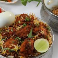 Hyd Goat Biryani · Spiced goat cooked with basmati rice and herbs.