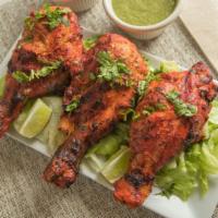Tandoori Chicken · Chicken leg pieces marinated overnight in yogurt, ginger, garlic and spices and cooked in th...