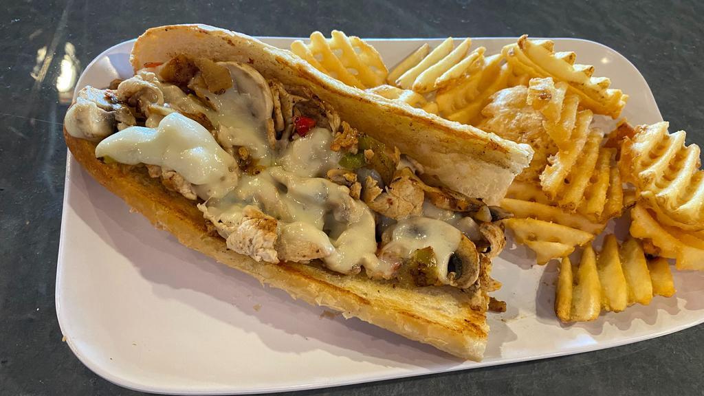 Chicken Philly · Sliced chicken, peppers and onion blend, mushrooms, and Swiss cheese on a hoagie bun. For extra zest, drizzled with cajun ranch. Served with au jus.