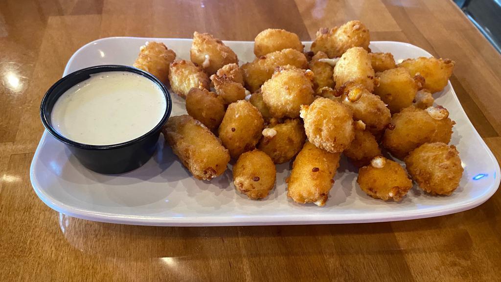 Cheese Curds · Real Wisconsin white cheddar lightly battered, fried to perfection, and served with your choice of dipping sauce.