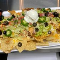 Half Size Mega Nachos · Fresh tortilla chips with your choice of beef or chicken, lettuce, tomato, jalapeños, black ...