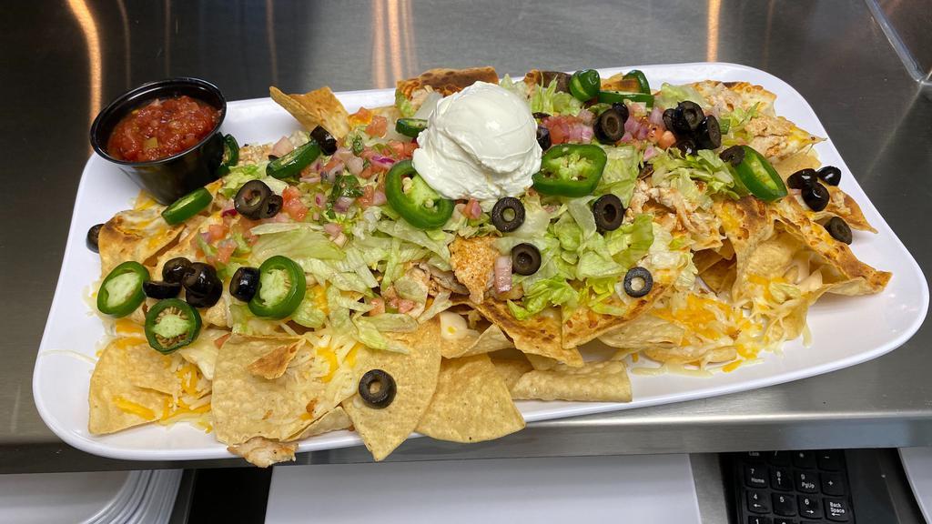 Mega Nachos · Fresh tortilla chips with your choice of beef or chicken, lettuce, tomato, jalapeños, black olives, onions, queso, sour cream, and shredded cheese. Comes with a side of our house-made salsa.