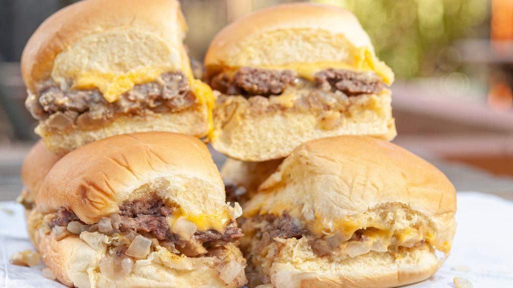Castle Sliders · Our signature burgers, served with onions, pickles and American cheese on Martin's potato rolls. Mustard is optional. 
**Onions are mandatory, it is how we cook the sliders**