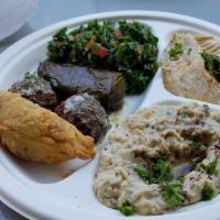 Traditional Platter · Hummus, tabouleh, baba ghannouge, a kibbeh, a grape leaf and two falafel.