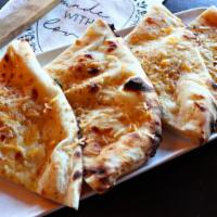 Cheddar Kulcha · Stuffed with melty cheddar & fontina cheese.