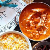 Butter Chicken · Chicken thigh pieces simmered in a hearty, smoky-sweet tomato & butter sauce.