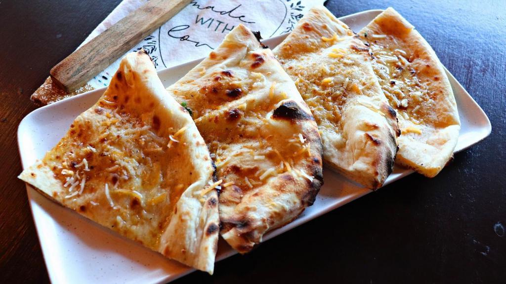 Cheddar Kulcha · India's version of a cheese quesadilla. Stuffed with melty cheddar & fontina cheese.
