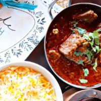 Lamb Rogan Josh · Fall-apart lamb simmered in a fiery Kashmiri red chili and fennel-spiced sauce.