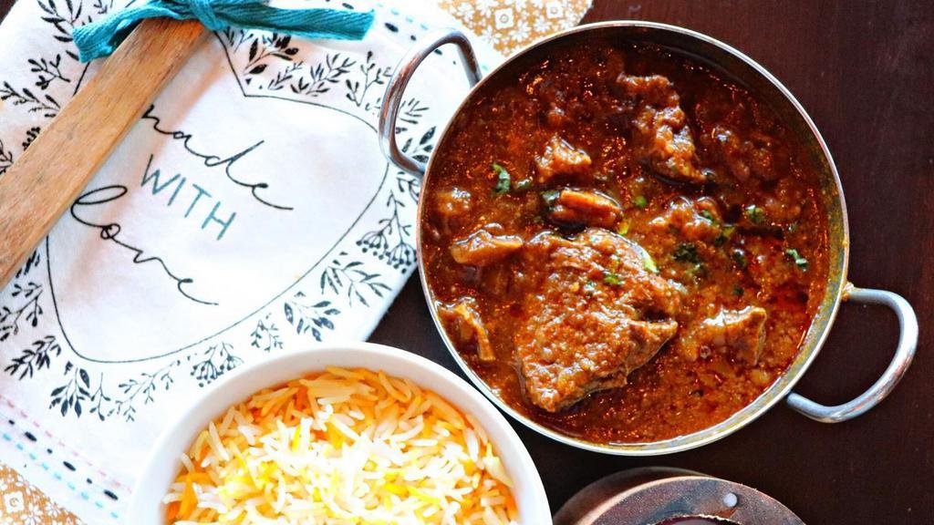 Goat Curry · Chunks of bone-in goat simmered in a hot, cumin and coriander-spiced sauce.