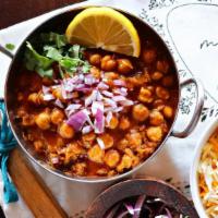 Chana Masala · Chickpeas simmered in a spiced onion and tomato sauce with a hint of lemon. Served with basm...